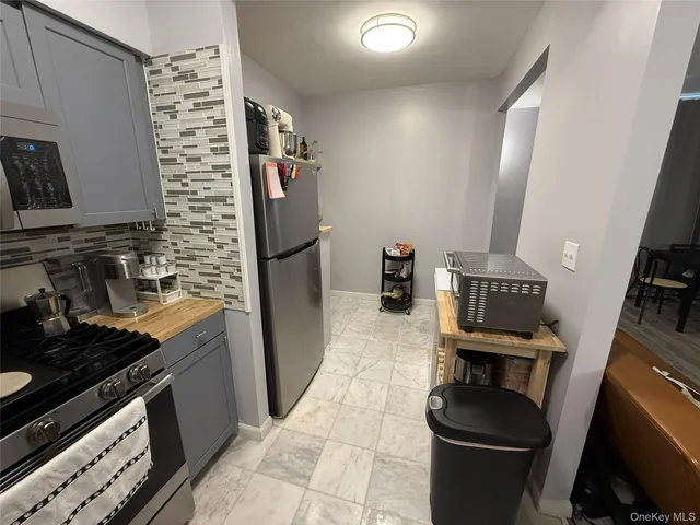 a kitchen with a refrigerator and a stove