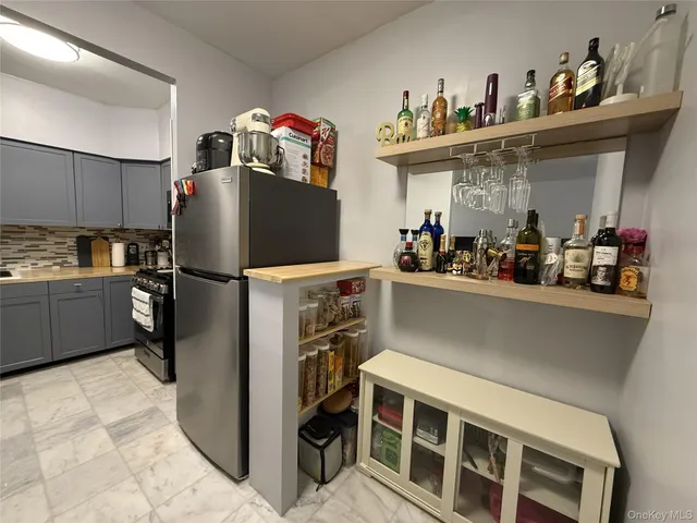 a kitchen with refrigerator and cabinets