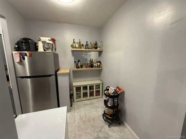 a kitchen with refrigerator and cabinets