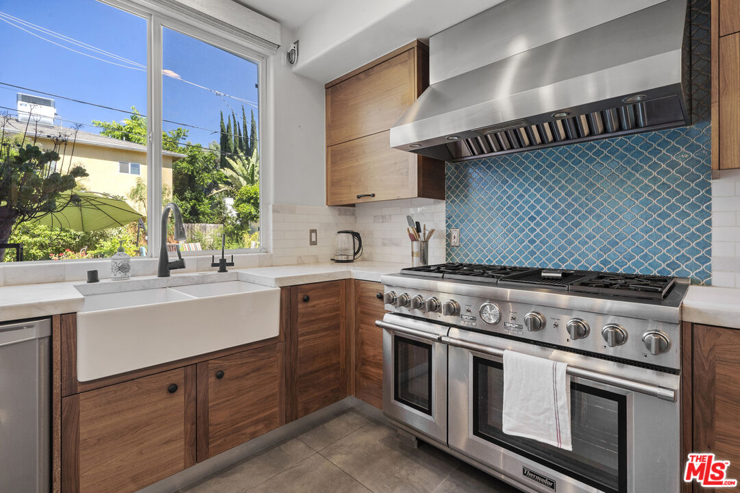 4544 Tobias Avenue Sherman Oaks, CA 91403 - Photo 18 of 55 a white stove top oven sitting inside of a kitchen