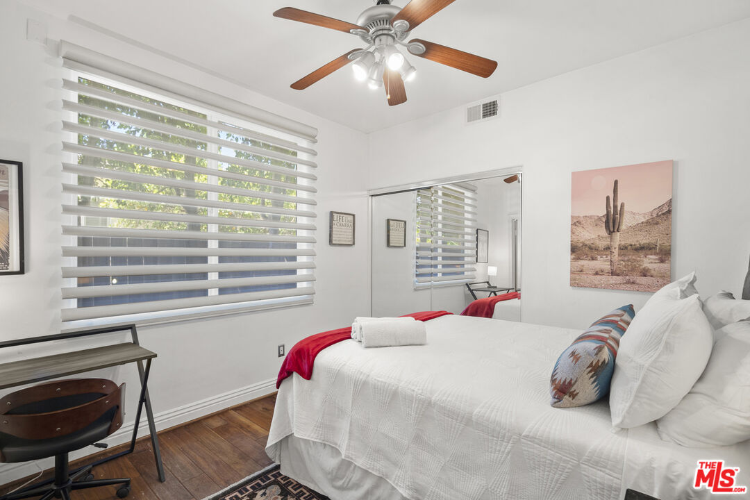 4544 Tobias Avenue Sherman Oaks, CA 91403 - Photo 19 of 55 a bedroom with a bed and a chandelier