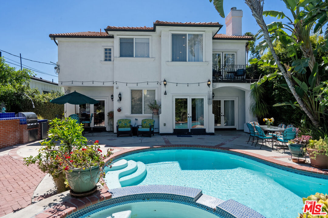 4544 Tobias Avenue Sherman Oaks, CA 91403 - Photo 2 of 55 a front view of a house with a yard table and chairs
