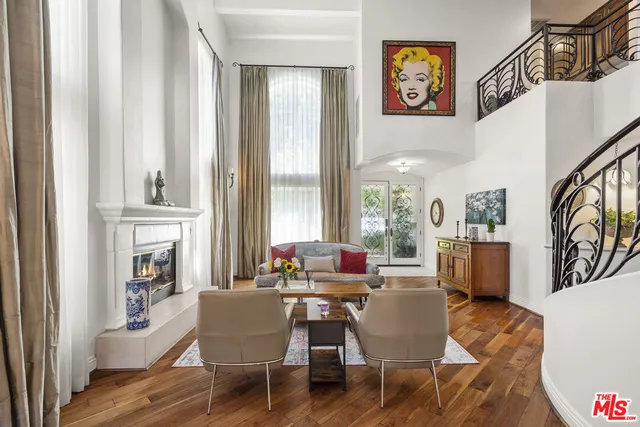 a dining room with furniture a chandelier and window