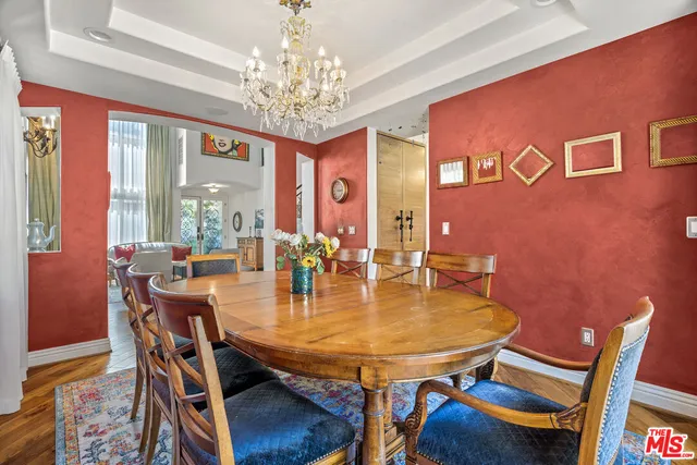 a kitchen with granite countertop a table chair and chandelier