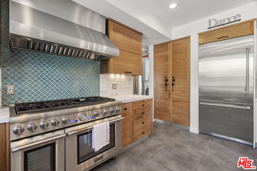 4544 Tobias Avenue Sherman Oaks, CA 91403 - Photo 30 of 55 a kitchen with stainless steel appliances granite countertop a stove and a refrigerator