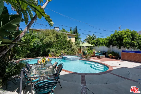 a swimming pool with outdoor seating