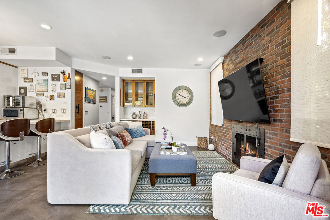 4544 Tobias Avenue Sherman Oaks, CA 91403 - Photo 36 of 55 a living room with furniture and a fireplace