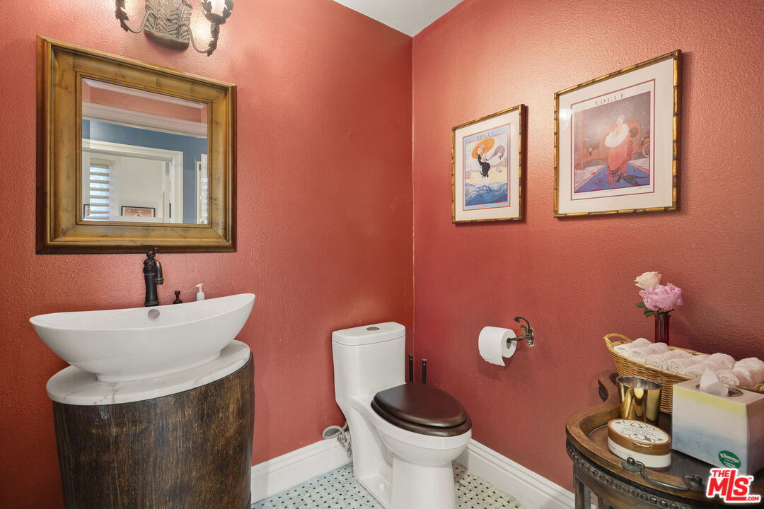 4544 Tobias Avenue Sherman Oaks, CA 91403 - Photo 41 of 55 a bathroom with a toilet a sink and mirror