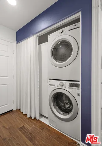 a white kitchen with a sink and living room view