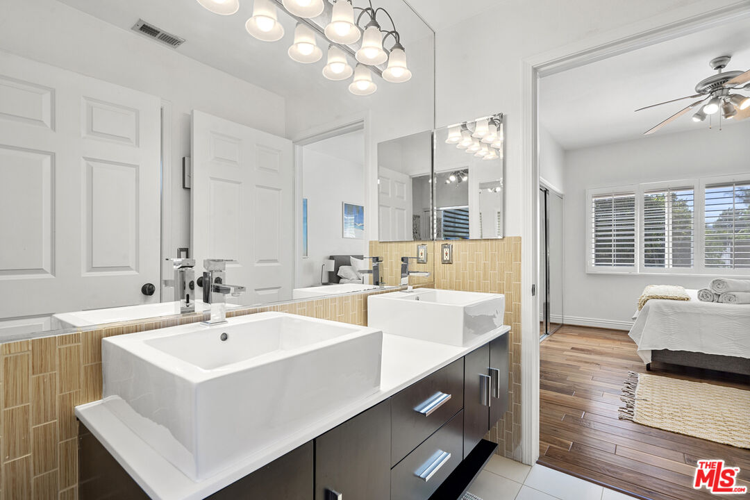4544 Tobias Avenue Sherman Oaks, CA 91403 - Photo 47 of 55 a white kitchen with a sink and living room view