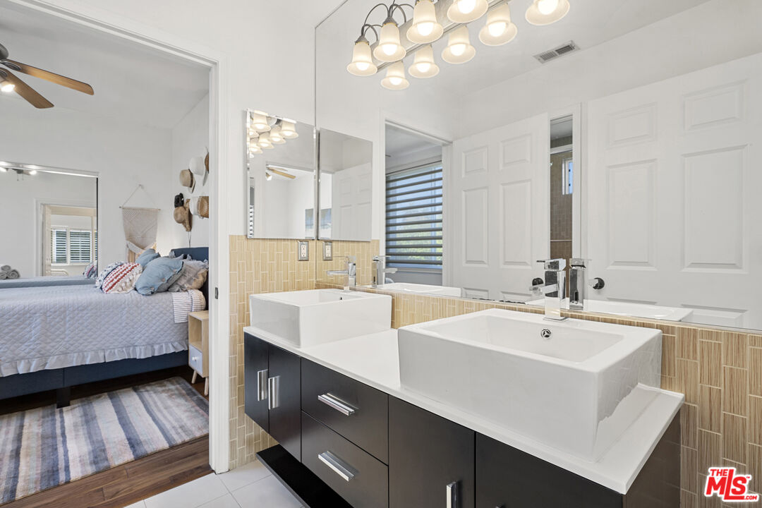 4544 Tobias Avenue Sherman Oaks, CA 91403 - Photo 48 of 55 a en suite bathroom with a sink and a large mirror