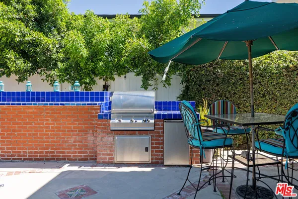 a view of an outdoor sitting area with brick wall