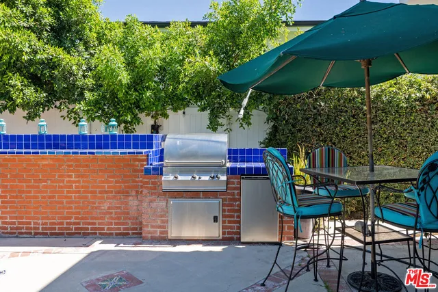 a view of an outdoor sitting area with brick wall