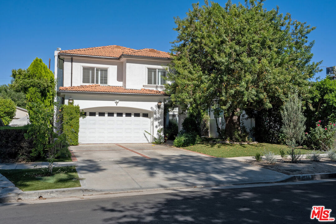 4544 Tobias Avenue Sherman Oaks, CA 91403 - Photo 10 of 55 a front view of a house with a yard and garage