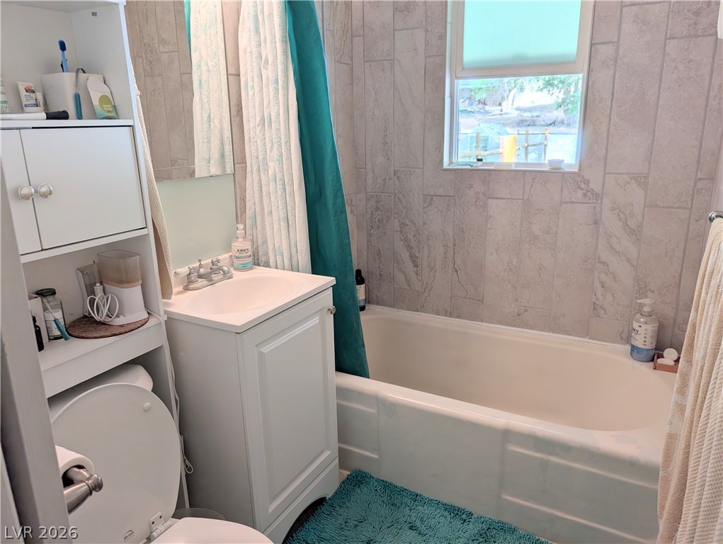 102 Rowan Drive Caliente, NV 89008 - Photo 16 of 28 A well-lit bathroom features tiled walls and a functional window.