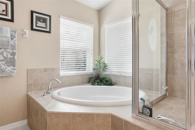a bath tub sitting in a bathroom next to a window
