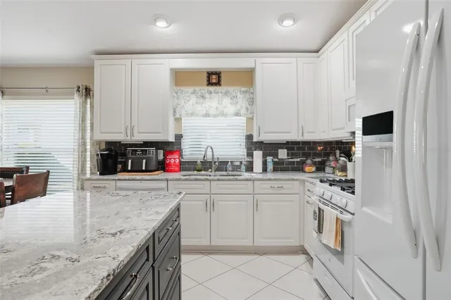 a kitchen with stainless steel appliances granite countertop a stove and a sink