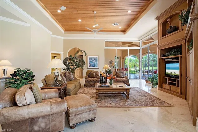 a living room with furniture ceiling fan and a rug