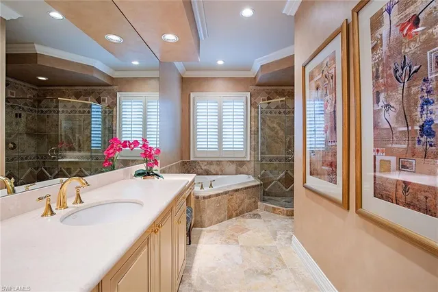 a bathroom with a granite countertop tub sink and mirror
