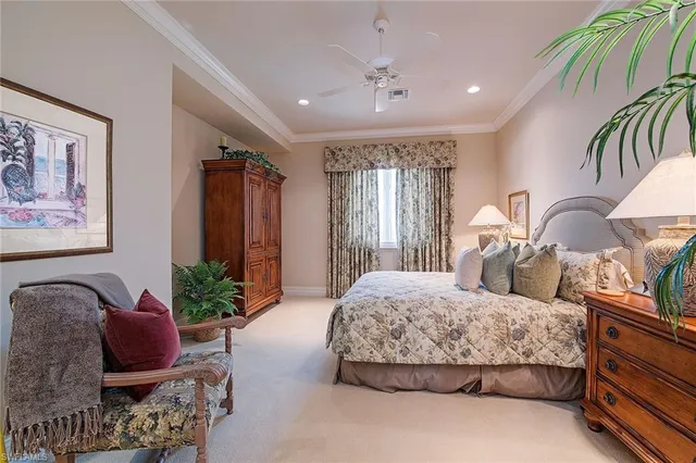 a bedroom with bed and flowerpot