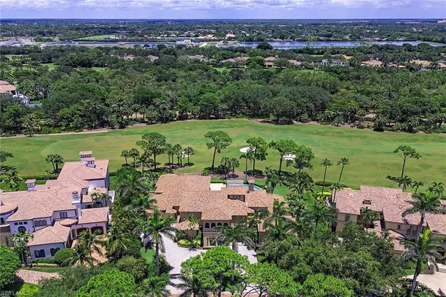 an aerial view of a houses with a yard