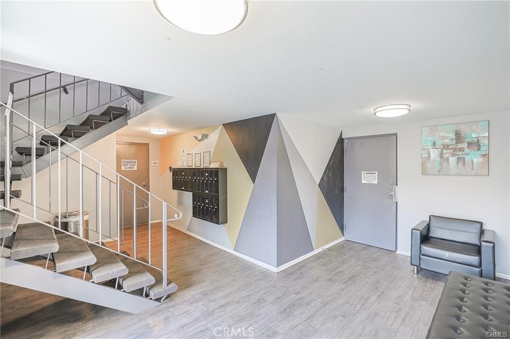 4406 Cahuenga Boulevard, Unit 202 Toluca Lake, CA 91602 - Photo 2 of 16 a view of entryway and hall with wooden floor
