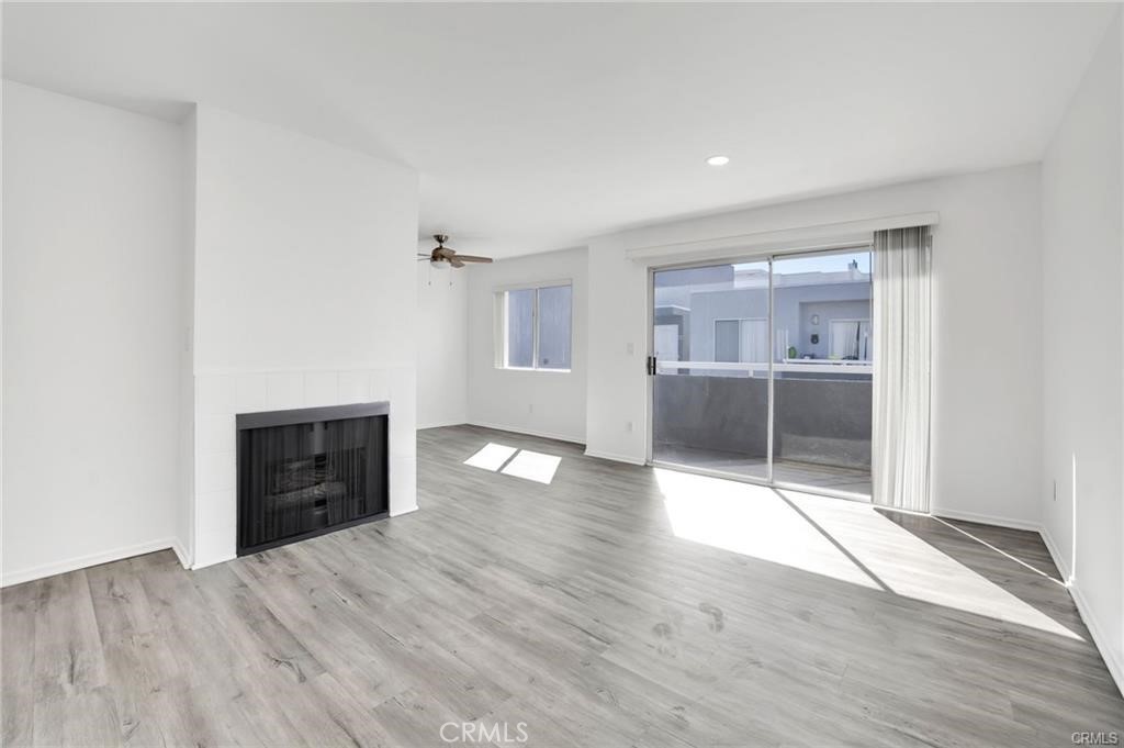 4406 Cahuenga Boulevard, Unit 202 Toluca Lake, CA 91602 - Photo 3 of 16 an empty room with wooden floor and natural light