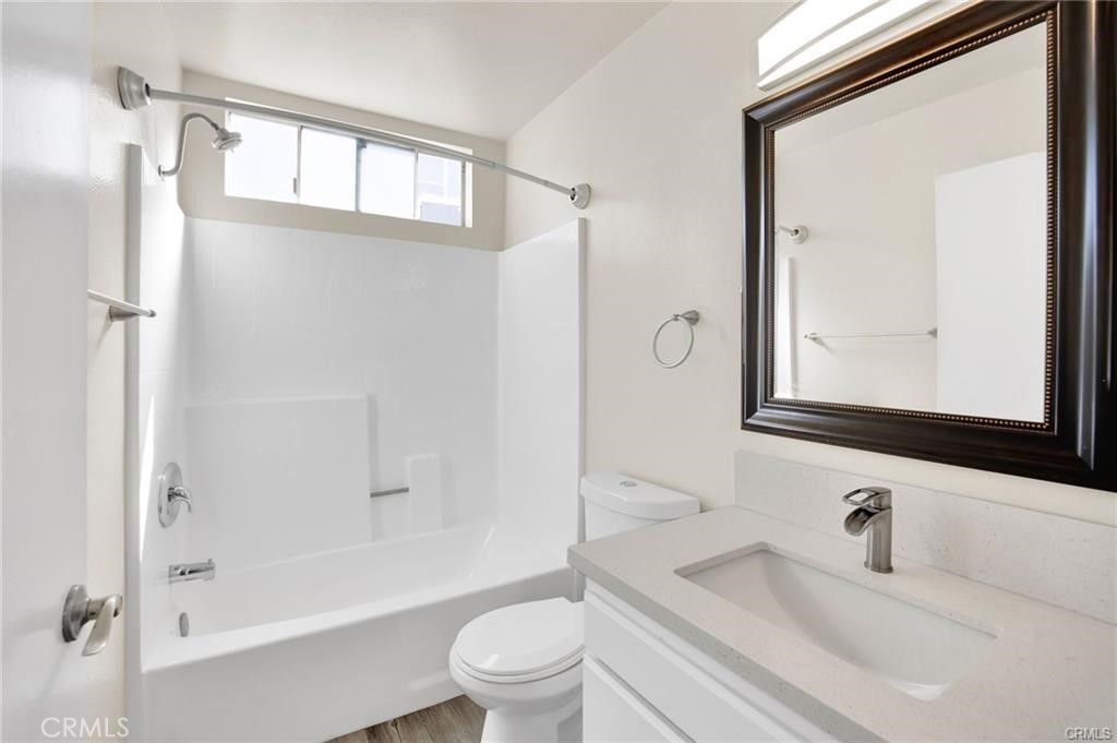 4406 Cahuenga Boulevard, Unit 202 Toluca Lake, CA 91602 - Photo 9 of 16 a bathroom with a bathtub shower sink vanity mirror and toilet