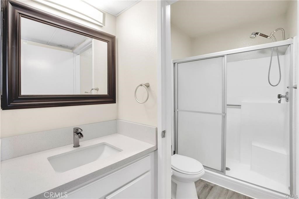 4406 Cahuenga Boulevard, Unit 202 Toluca Lake, CA 91602 - Photo 10 of 16 a bathroom with a sink vanity mirror and toilet