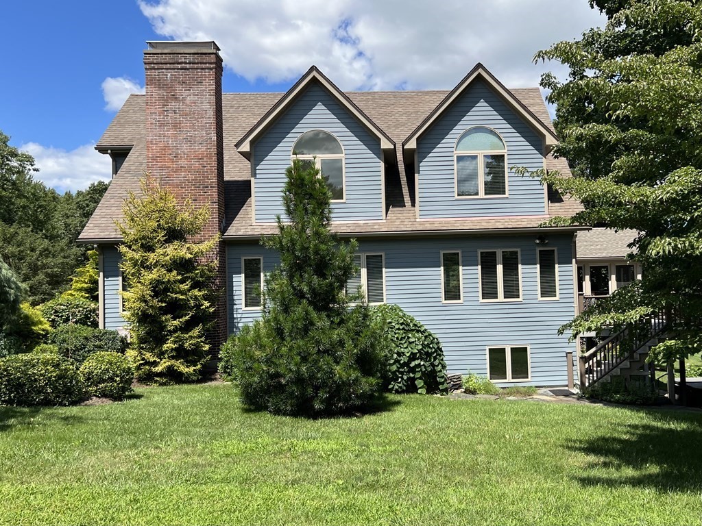 60 Country Corners Road Amherst, MA 01002 - Photo 3 of 42 a front view of a house with a garden