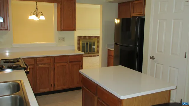 a kitchen with a refrigerator and a sink