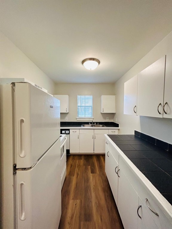 3629 North MacGregor Way, Unit 137 Houston, TX 77004 - Photo 8 of 15 a kitchen with a refrigerator and white cabinets