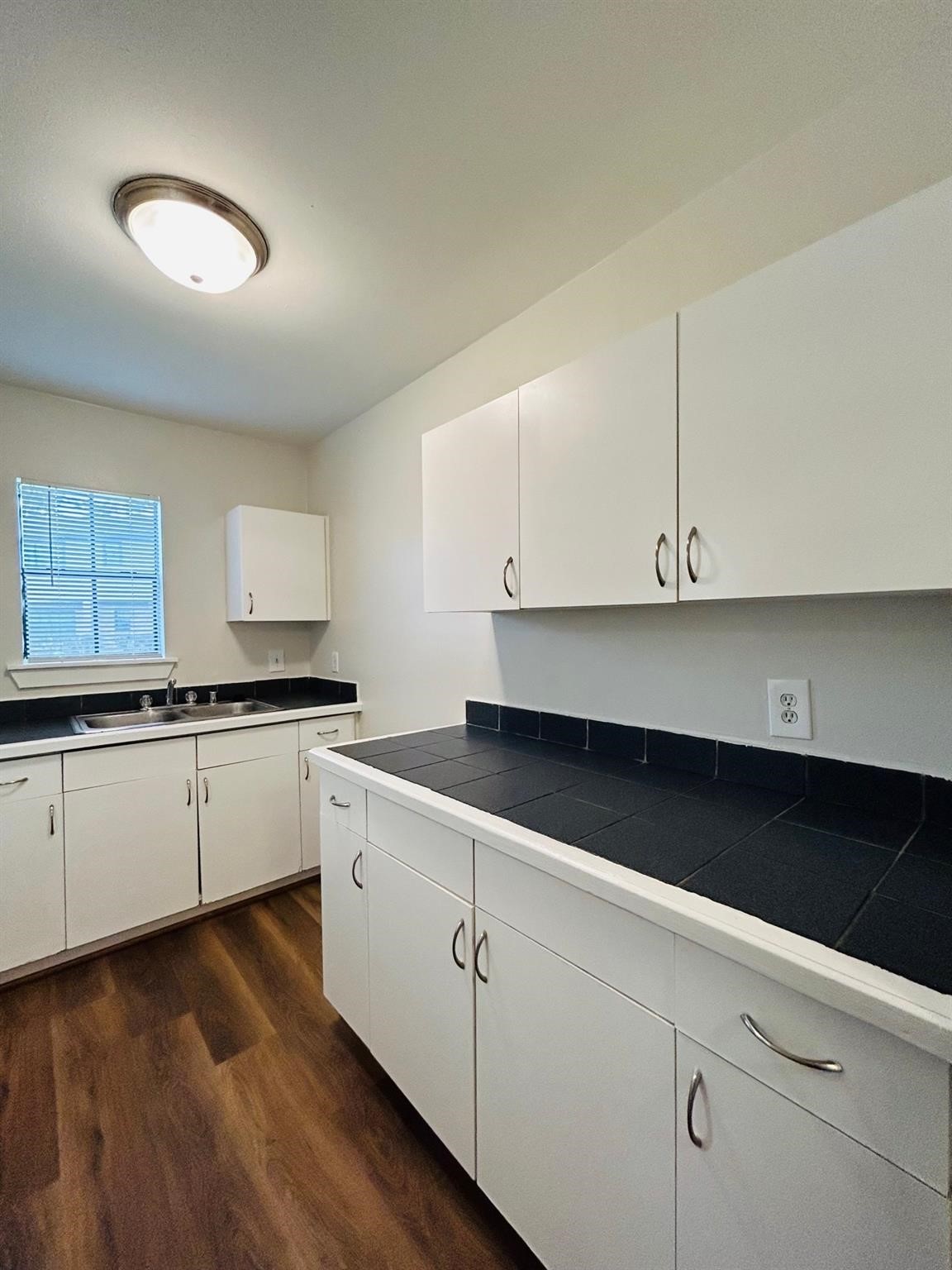 3629 North MacGregor Way, Unit 137 Houston, TX 77004 - Photo 10 of 15 a kitchen with granite countertop white cabinets and white appliances