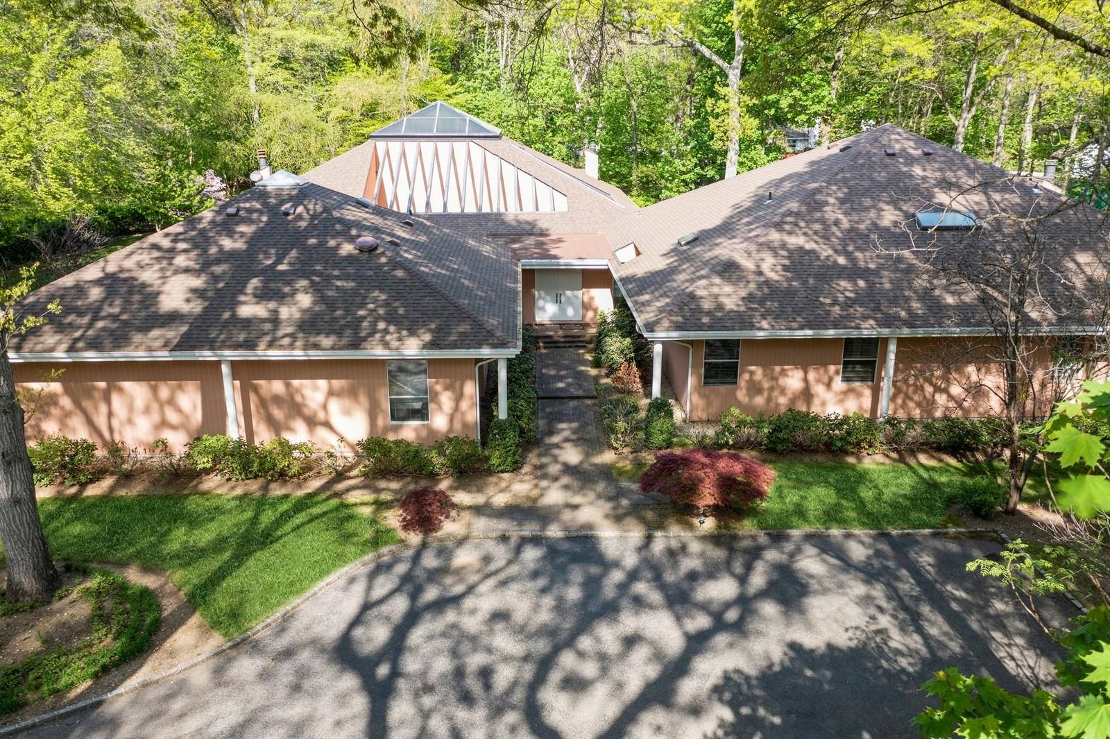 2323 Cedar Swamp Road Glen Head, NY 11545 - Photo 1 of 1 View of front facade with a shingled roof, a front lawn, and a forest view
