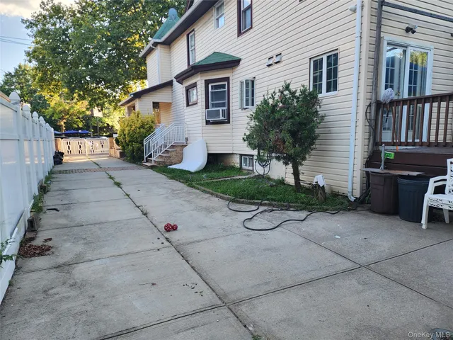 a view of a backyard with sitting area and garden