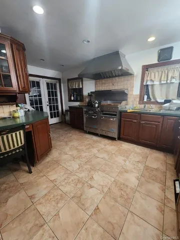 a kitchen with stainless steel appliances granite countertop a stove and a refrigerator