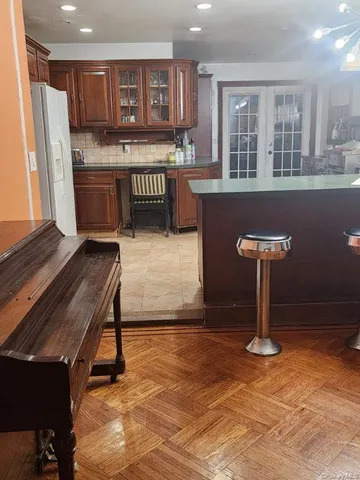 a kitchen with a refrigerator and a sink