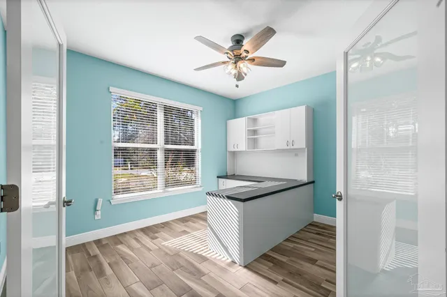 a view of a hallway with wooden floor