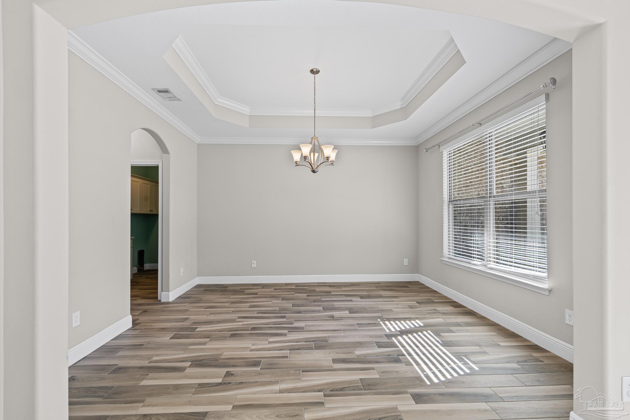 7166 Jasper Street Navarre, FL 32566 - Photo 18 of 71 a view of an empty room with wooden floor and a window