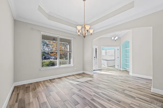 an empty room with a ceiling fan and window