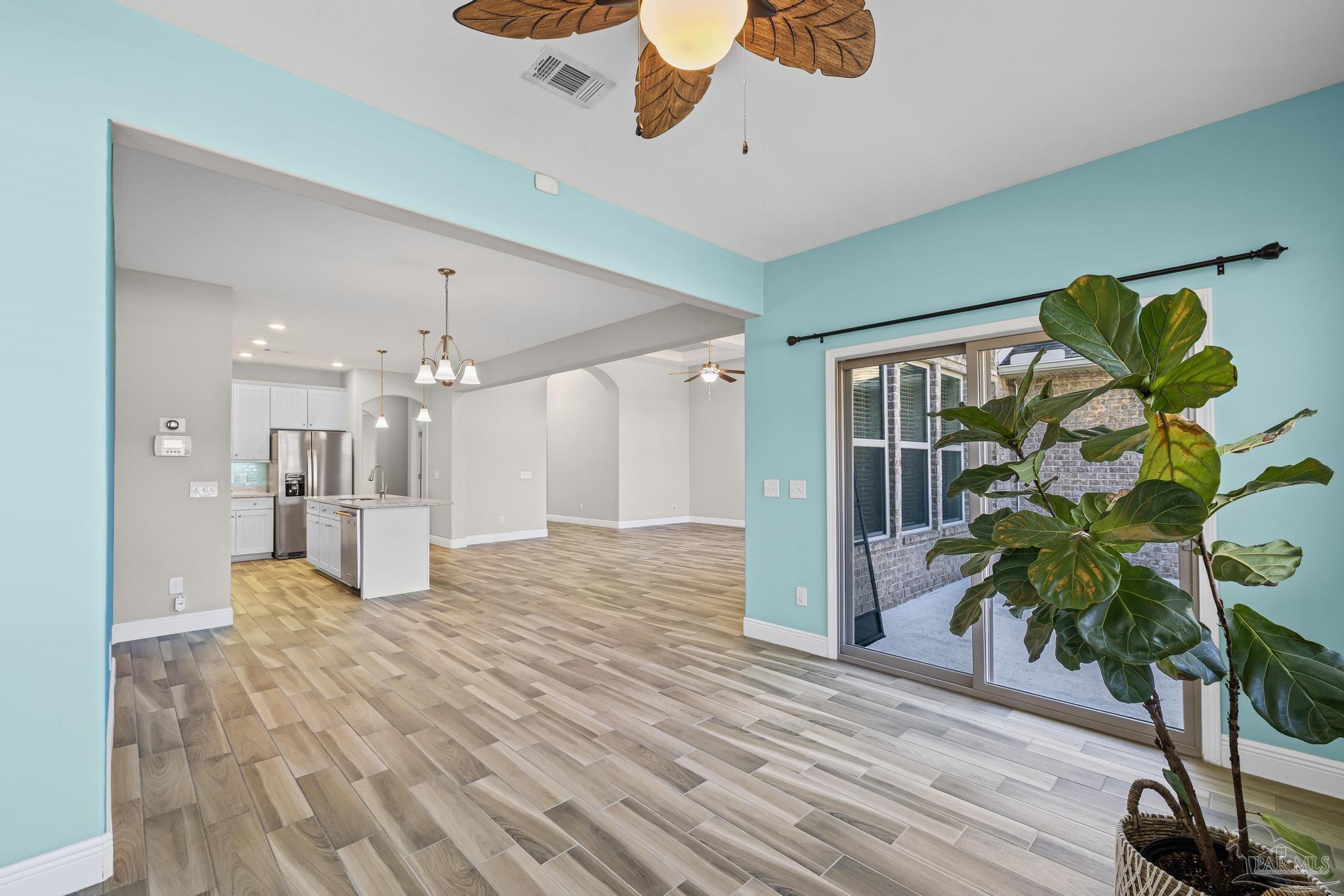 7166 Jasper Street Navarre, FL 32566 - Photo 24 of 71 a view of a hallway with wooden floor