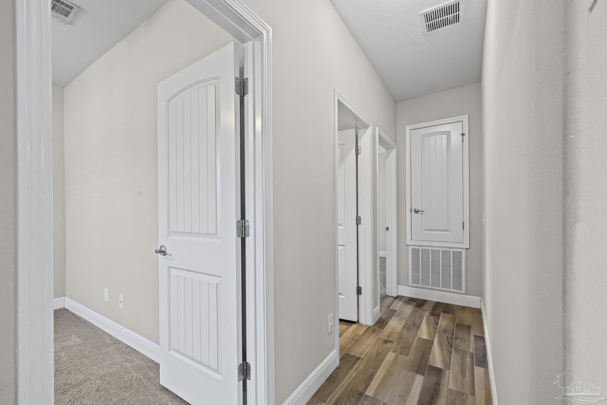 7166 Jasper Street Navarre, FL 32566 - Photo 25 of 71 a view of a room with wooden floor and a bathroom