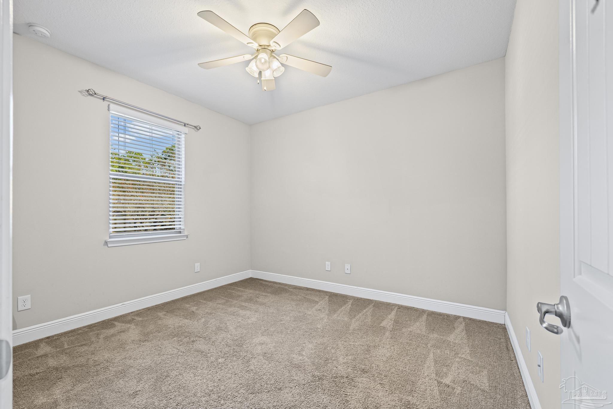 7166 Jasper Street Navarre, FL 32566 - Photo 26 of 71 an empty room with a window and a fan