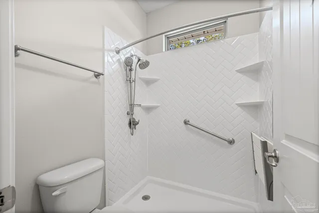 an empty room that has a chandelier and a chandelier fan