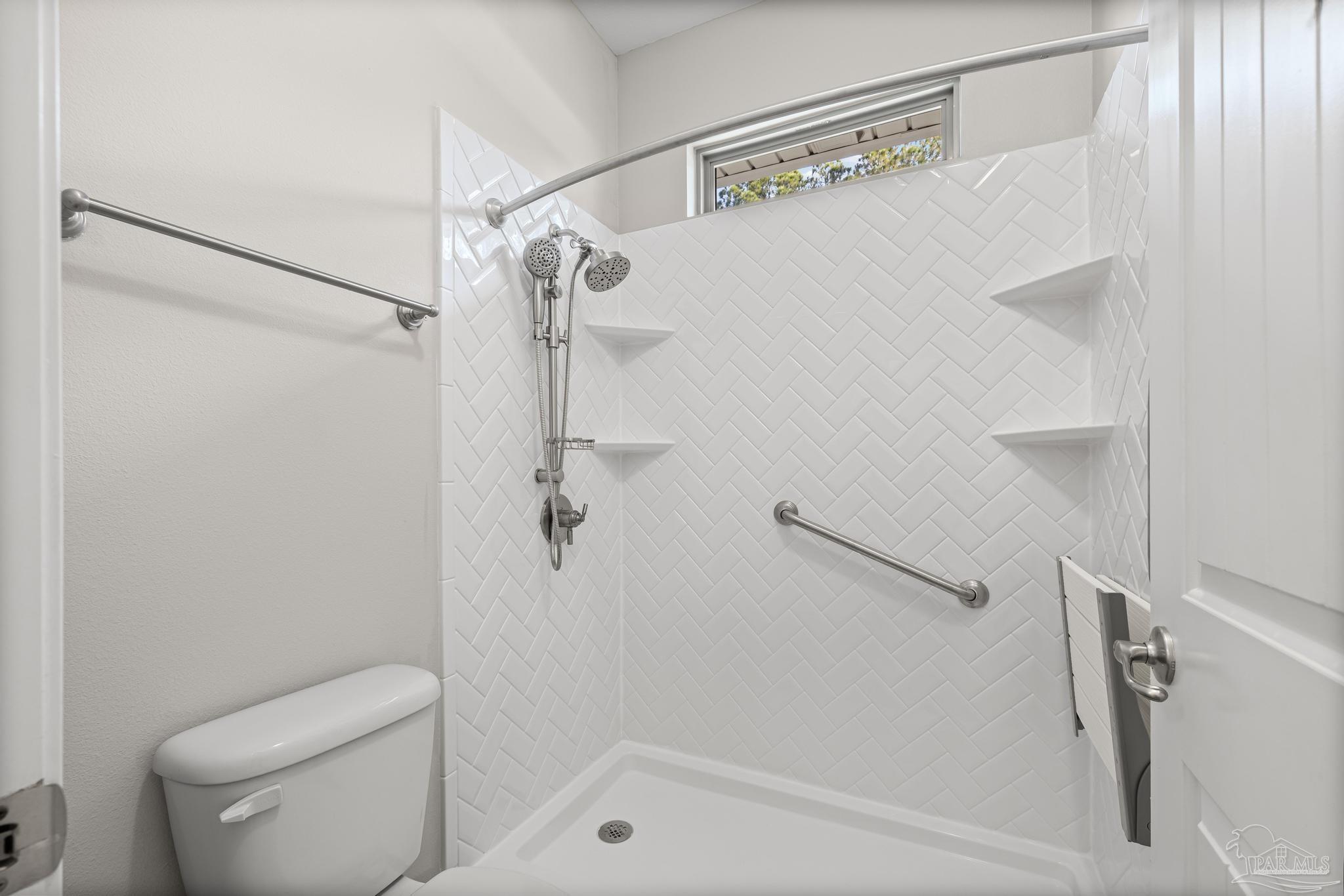 7166 Jasper Street Navarre, FL 32566 - Photo 29 of 71 a bathroom with a shower and toilet