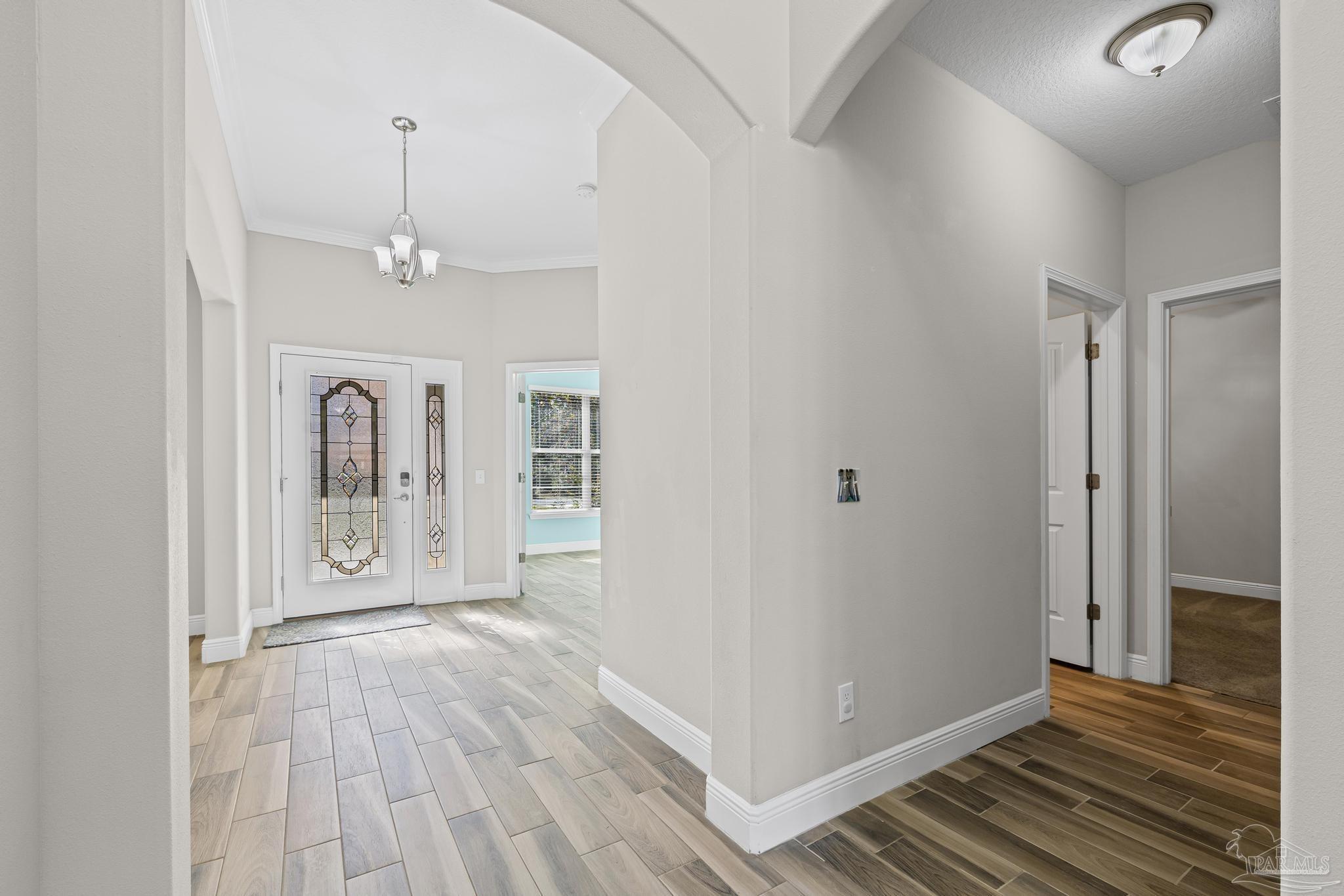 7166 Jasper Street Navarre, FL 32566 - Photo 30 of 71 a view of a hallway view with wooden floor and staircase