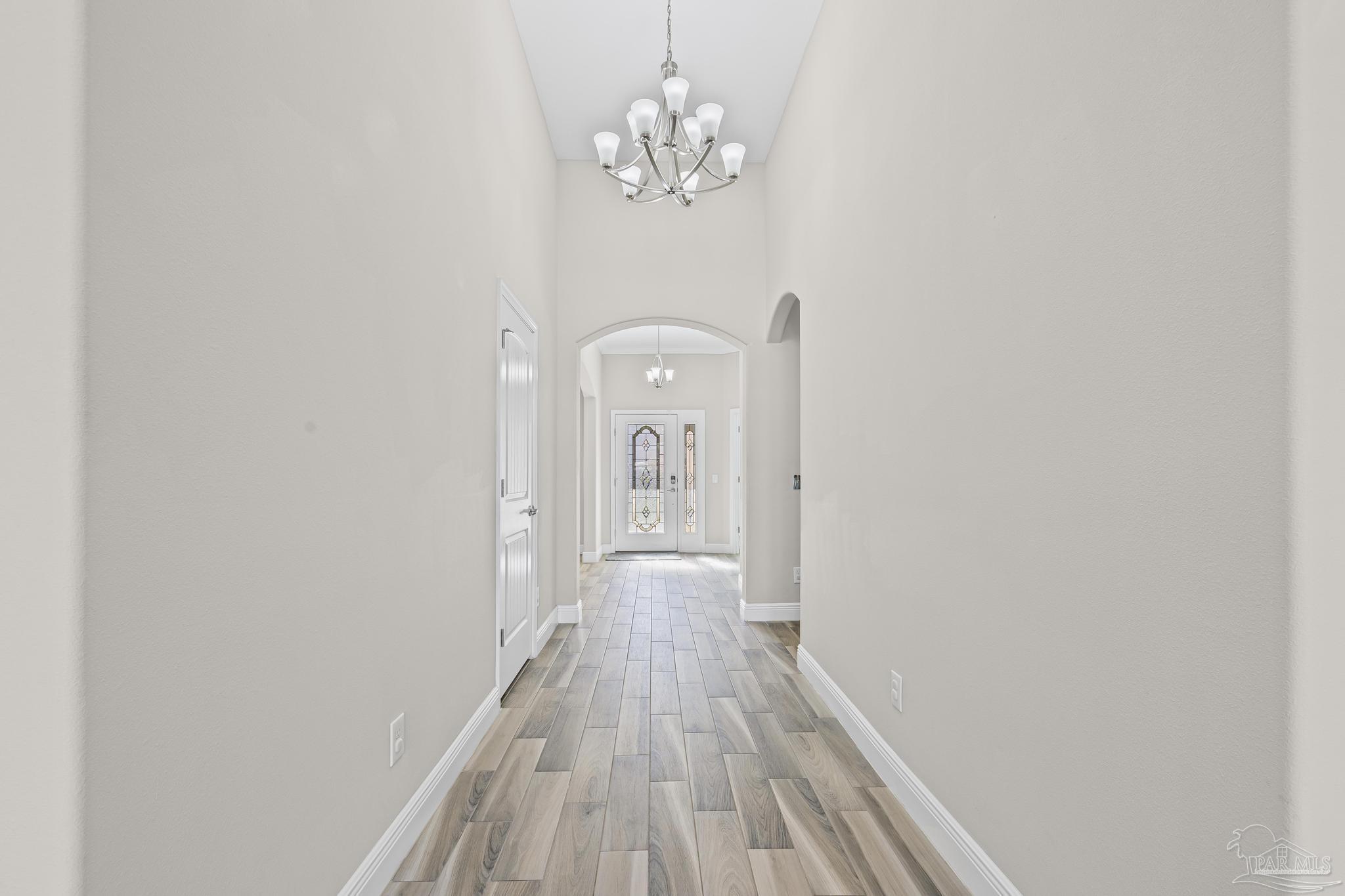 7166 Jasper Street Navarre, FL 32566 - Photo 31 of 71 a view of a hallway with wooden floor