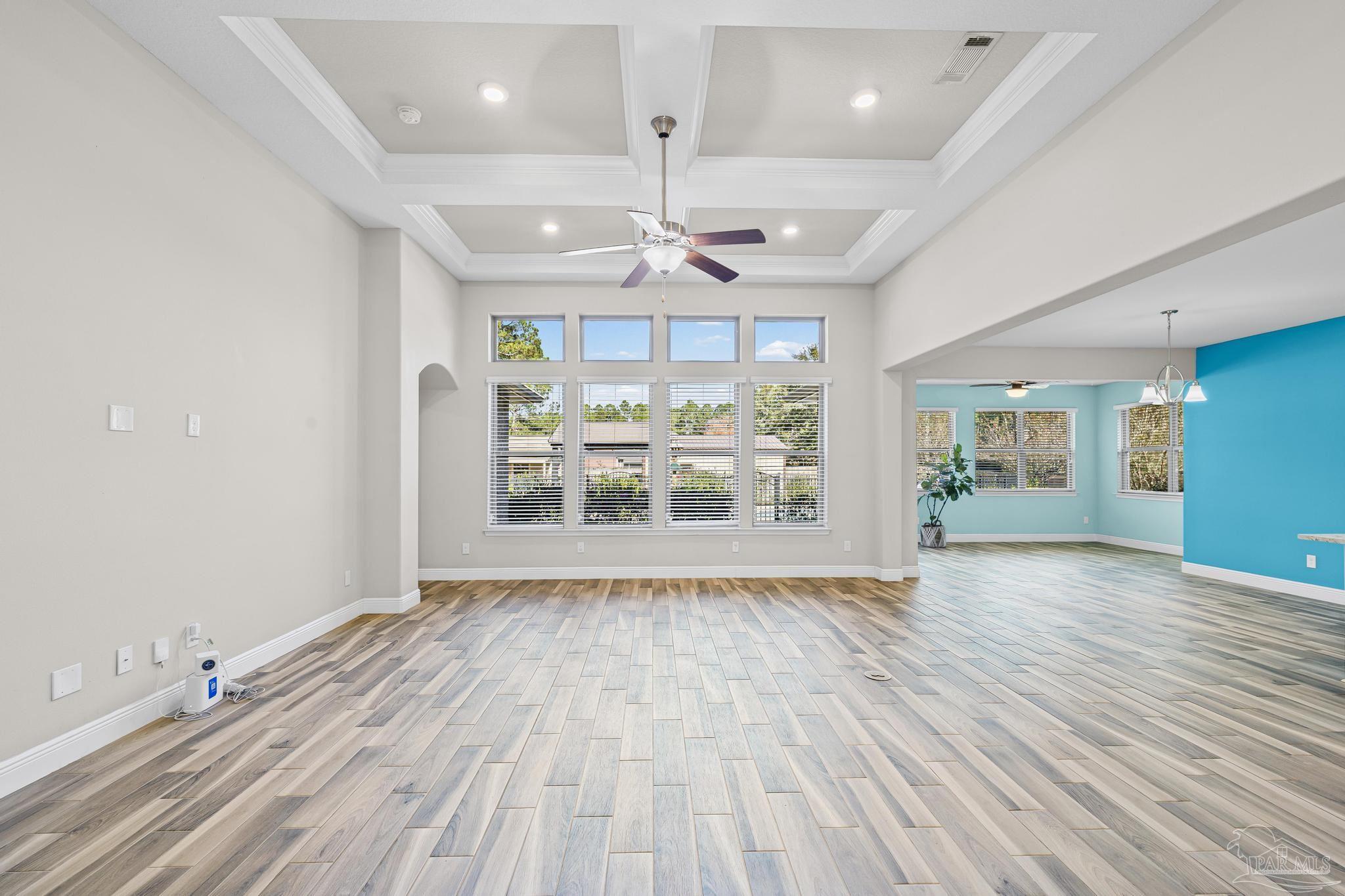 7166 Jasper Street Navarre, FL 32566 - Photo 32 of 71 a view of an empty room with wooden floor and a window