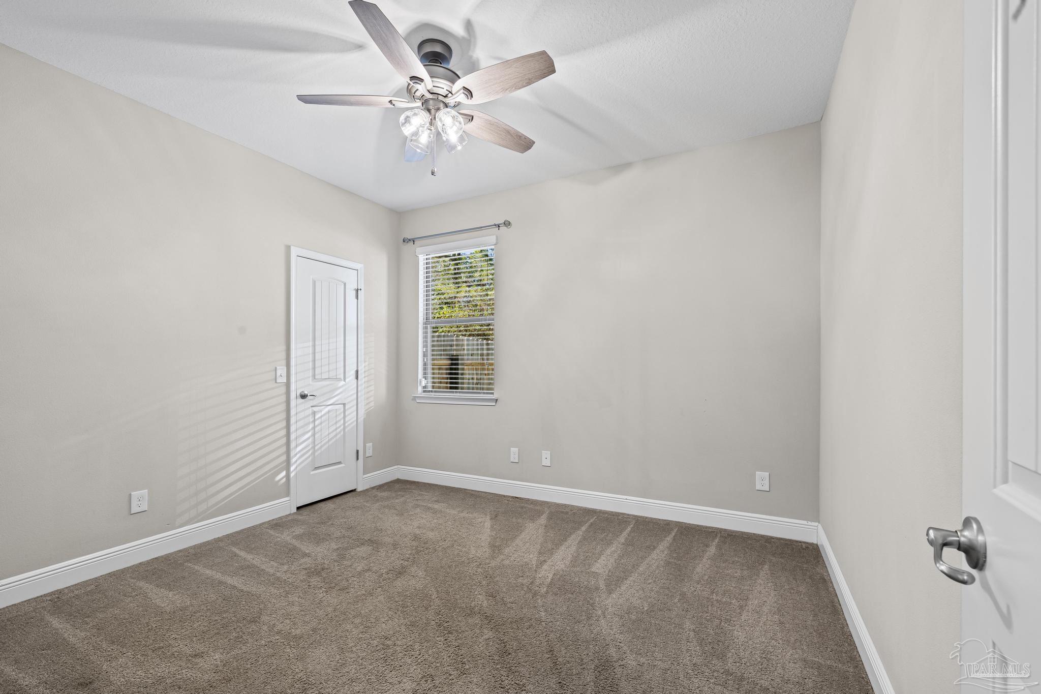 7166 Jasper Street Navarre, FL 32566 - Photo 33 of 71 an empty room with windows and fan