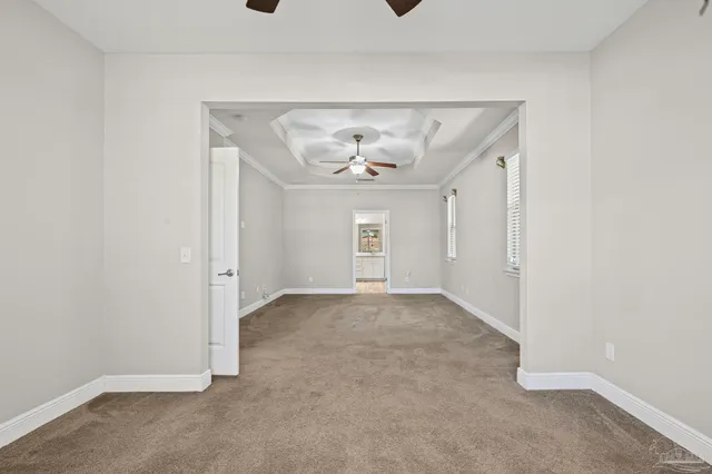 a view of a house with a yard and large tree
